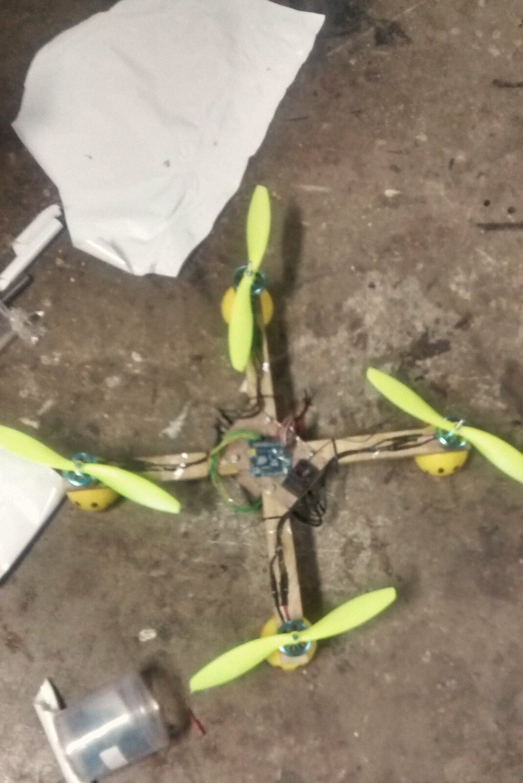 Our first quadcopter: wooden crossmember arms, yellow motor domes, and an Arduino wired in as the flight controller