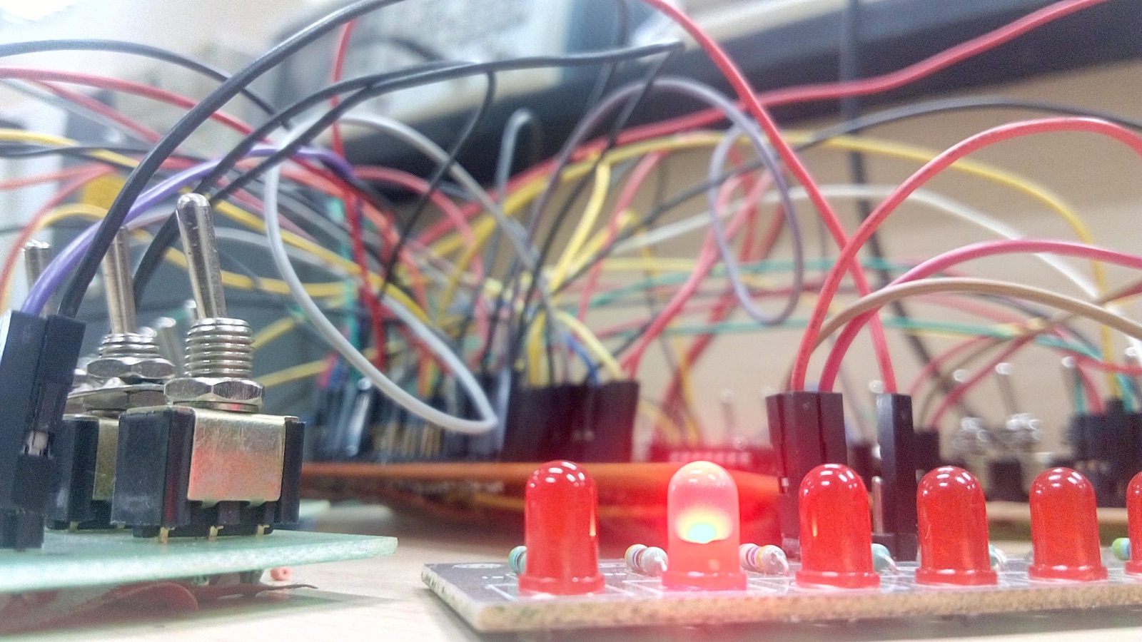 The control electronics mid-development: toggle switches, an indicator LED board, and more jumper wires than any diagram admits to