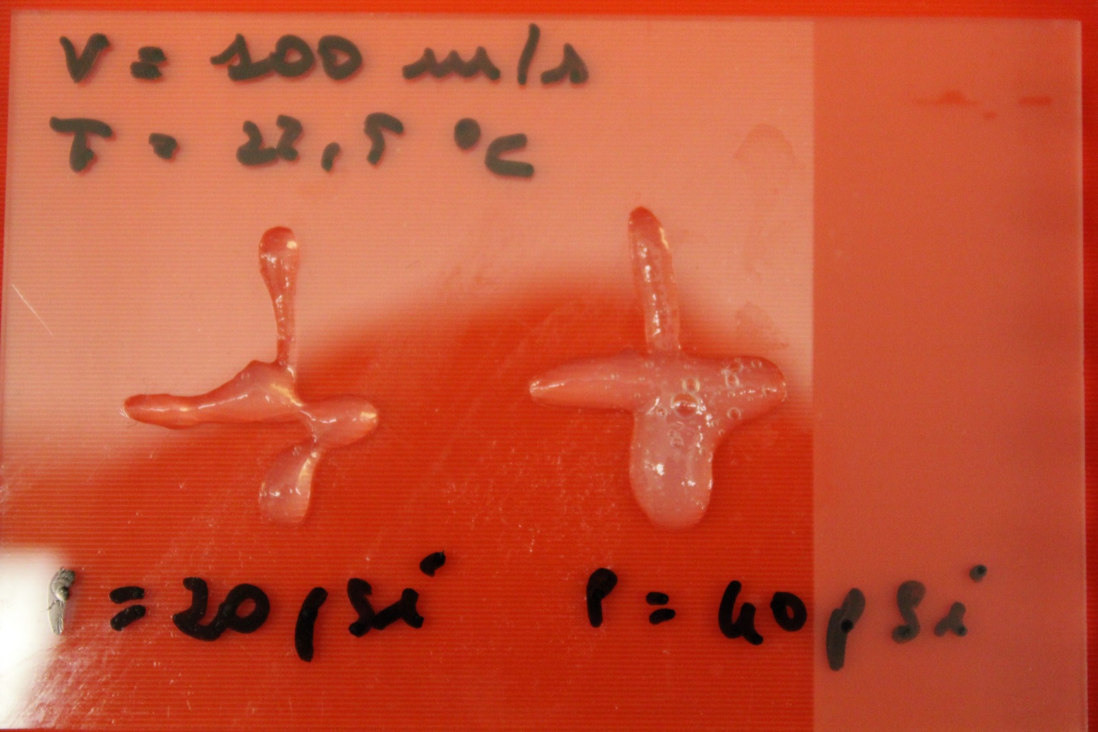 Two test extrusions of GelMA ink at 20 and 40 psi, printed at 100 mm/s and 22.5 °C, with the parameters written on the plate in marker